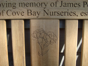 Carnation flower carved into wood on a memorial bench - 4mb2950