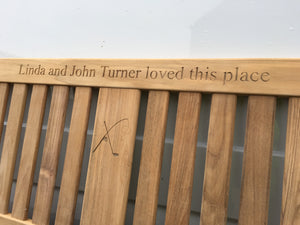 memorial bench with a fishing rod and golf club carved into the wood-4mb4093