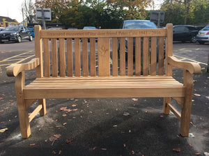 memorial bench with a dove, carrying an olive branch in its beak, carved into the wood - 4mb4578